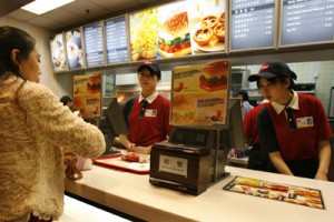 KFC workers attend to a customer at a KFC outlet in Beijing